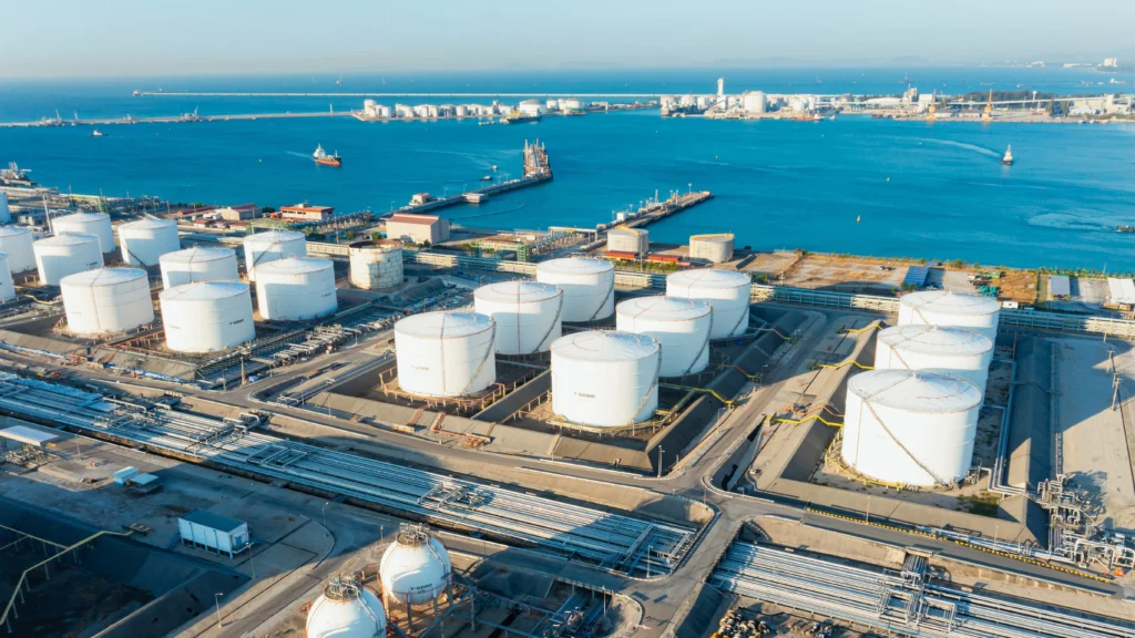 Aerial view of optimized industrial storage tanks next to a port.