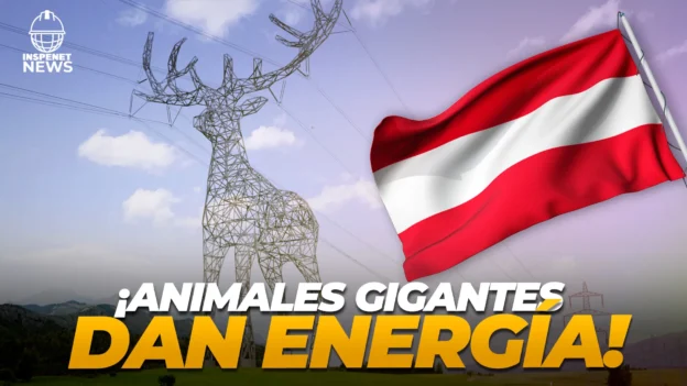 Estructura metálica con forma de ciervo que funciona como torre eléctrica en un paisaje montañoso de Austria, junto a una bandera austriaca ondeando y el texto “¡Animales gigantes dan energía!”.