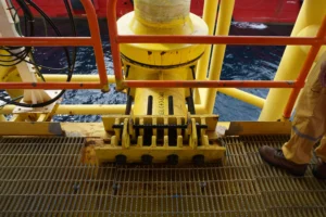 Estructura de un riser offshore en plataforma marina durante una inspección de risers, mostrando el soporte y sujeción del conducto sobre la cubierta.