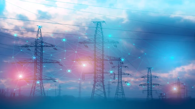 Power transmission towers connected by a digital network representing the use of artificial intelligence in the energy sector