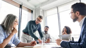 Team of professionals in a meeting analyzing operational and integrity management decisions within an organization.