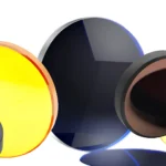 Optical lenses and infrared windows made of zinc selenide (yellow) and germanium (dark) for thermal camera housings.