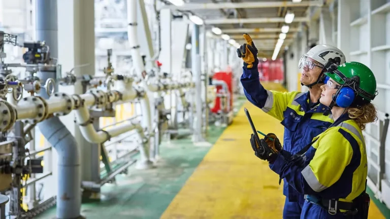 Técnicos de Aker Solutions inspeccionan instalaciones industriales como parte de servicios de ingeniería e integridad.