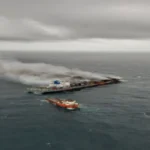 Wan Hai 503 is towed to a port in the Middle East.