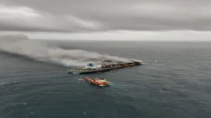 Wan Hai 503 is towed to a port in the Middle East.
