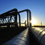 Oleoducto y gasoducto en operación al atardecer