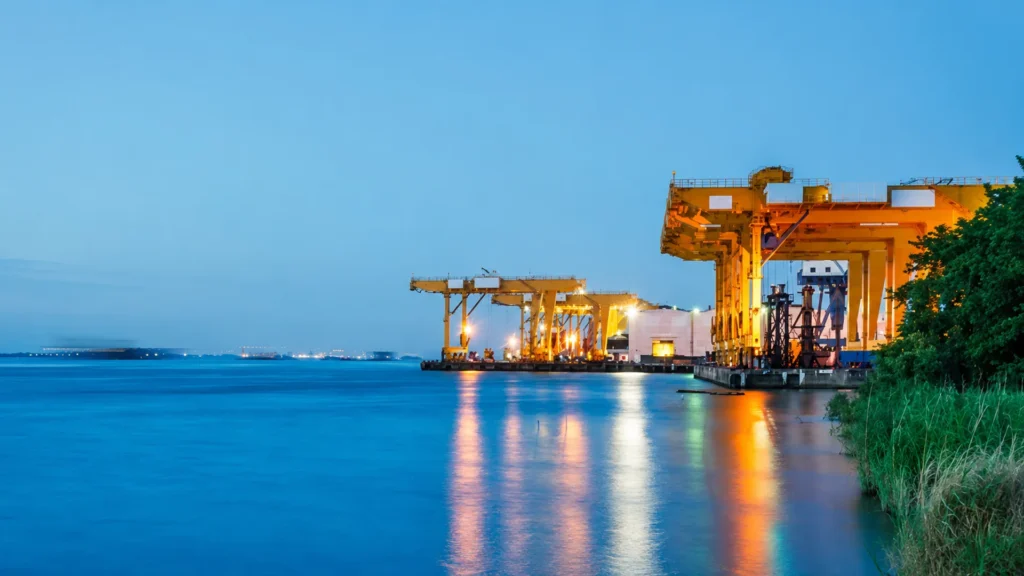 Offshore operations supported by industrial port infrastructure and marine cargo cranes.